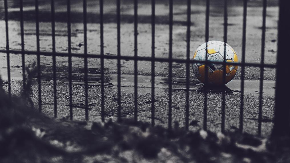 a soccer ball in a grey rainy playground