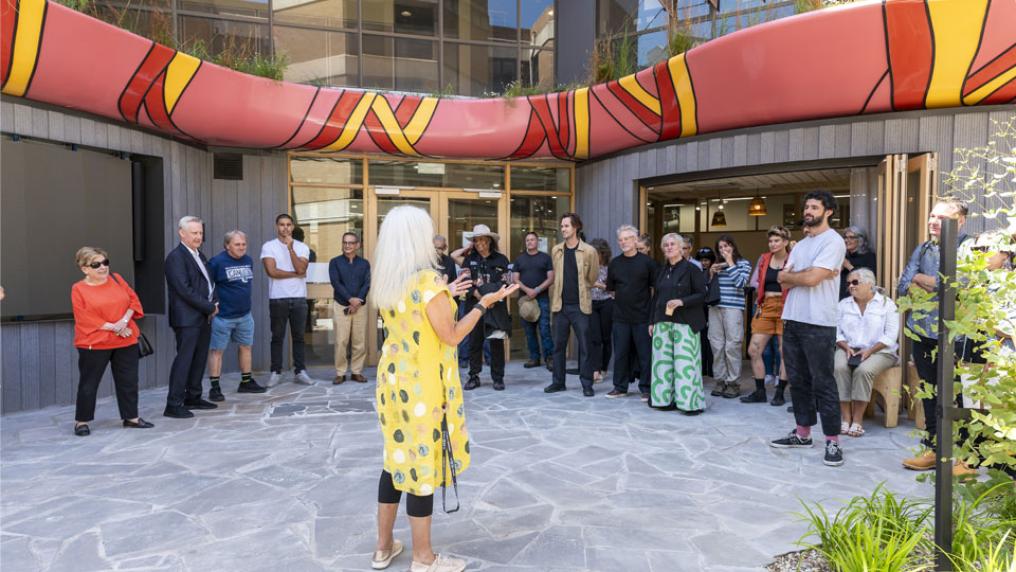Karen Jackson speaking to a group of approximately 30 attendees at the Moondani Balluk garden opening.