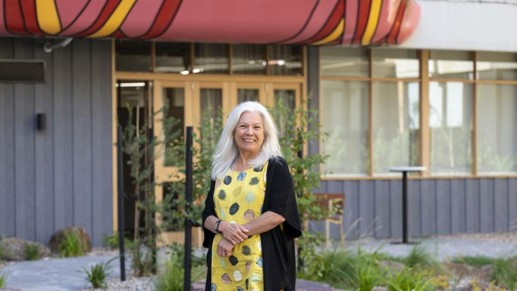 Karen Jackson (KJ) standing in the Moondani Ballluk garden. KJ is smiling at the camera.