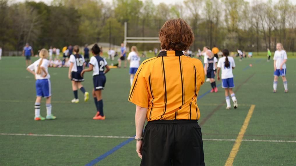 Referee at female football game.