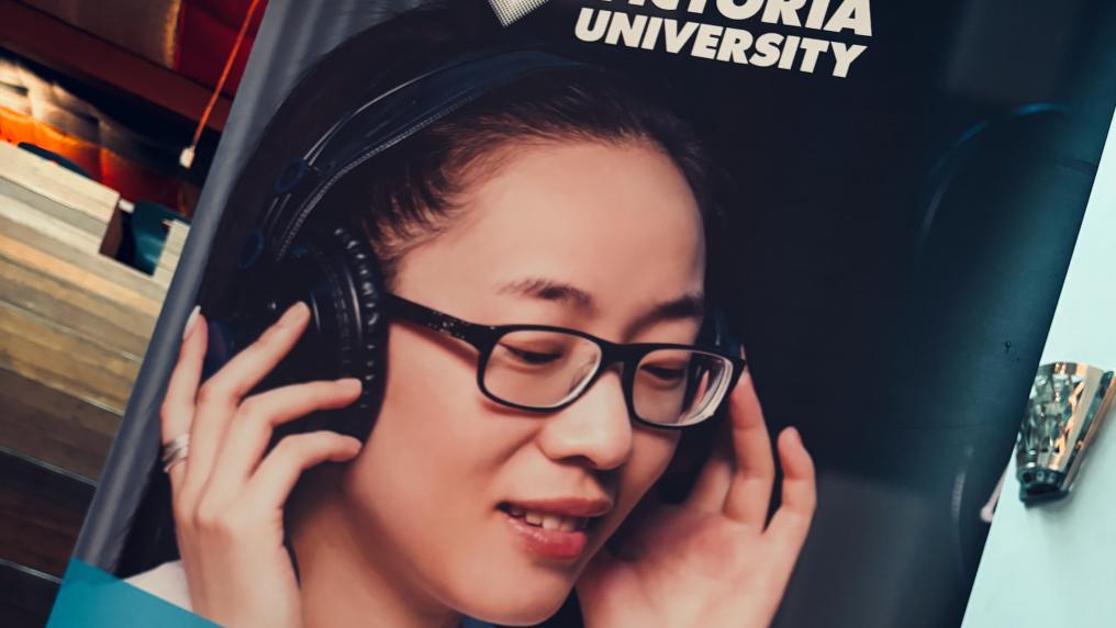 Poster of a student listening to music through headphones