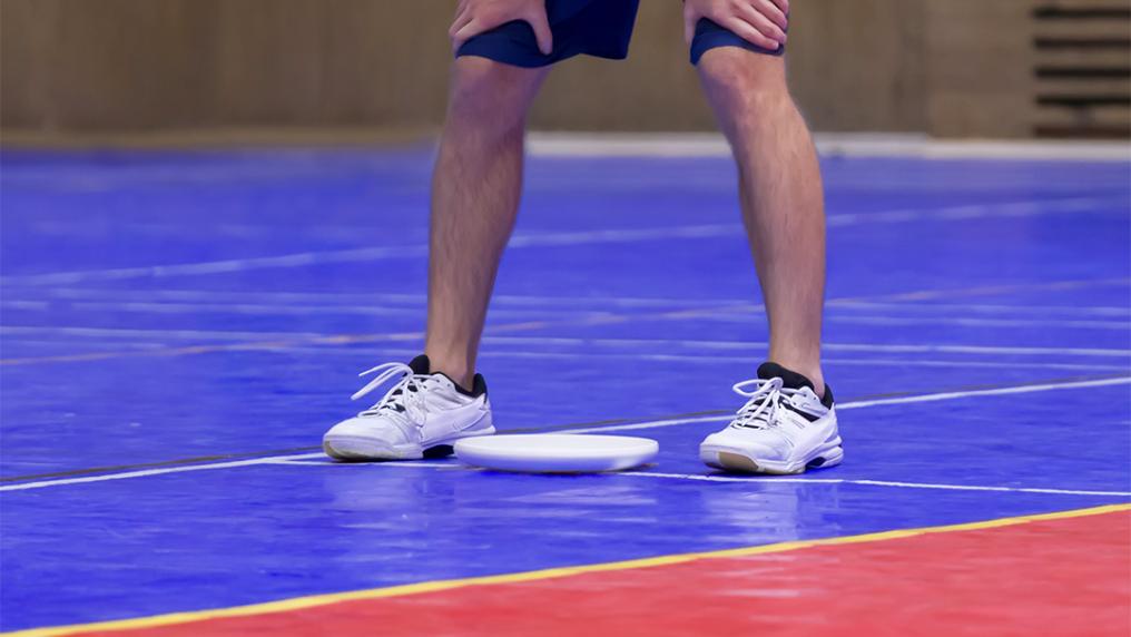 Participant playing indoor frisbee.