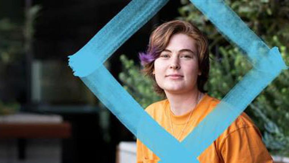 VU student behind blue diamond. 