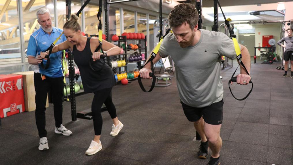 Gym goers are coached on the TRX at the Footscray Park Campus Fitness Centre.