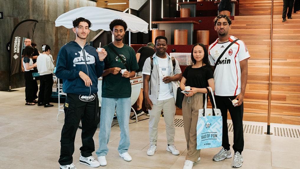 A group of young people in a modern foyer