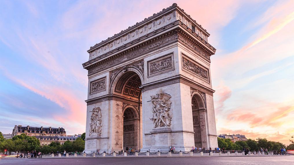 The Arc de Triomphe in Paris at sunset.