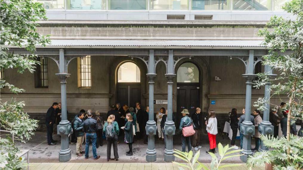 Conference attendees chatting outside the Queen St building, City Campus