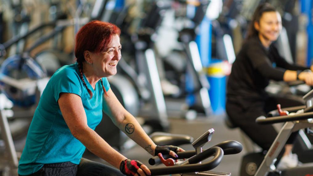 Two women cycle on the exercise bikes at Footscray Park Fitness Centre