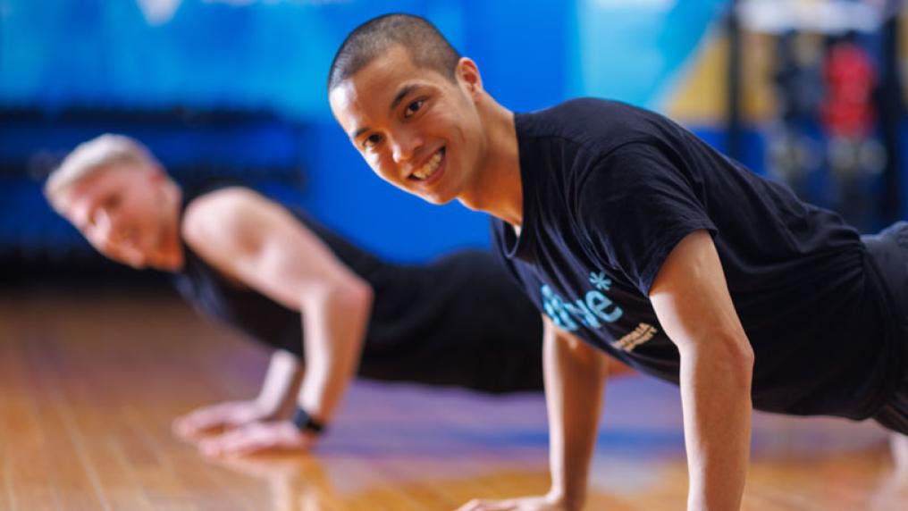 Two people do push ups at the Footscray Park gym