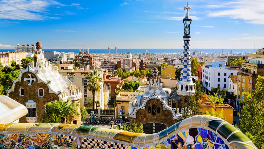A view of Barcelona, Spain form Park Güell with the colorful mosaic buildings in the foreground
