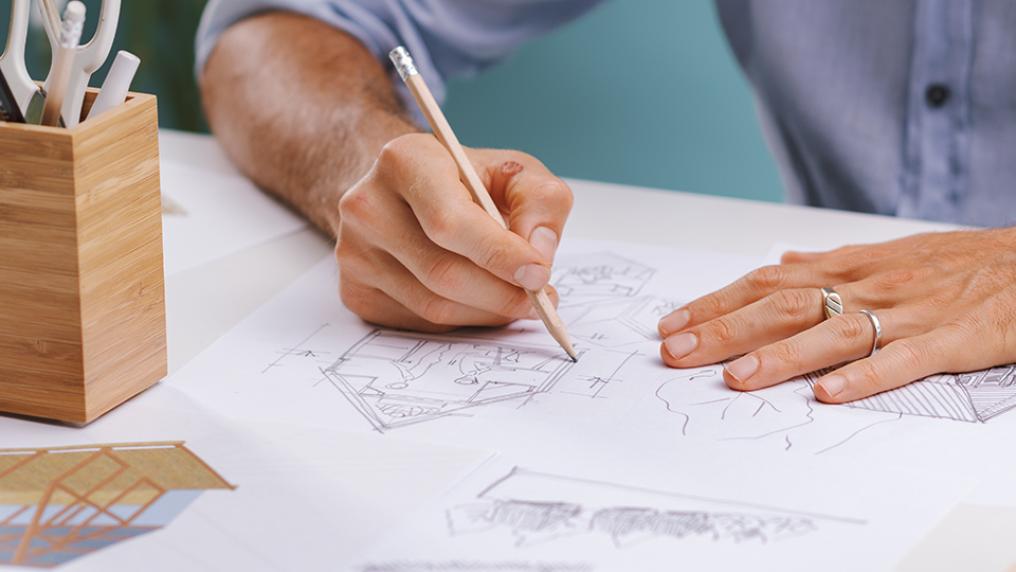 An architecture design student draws a building.