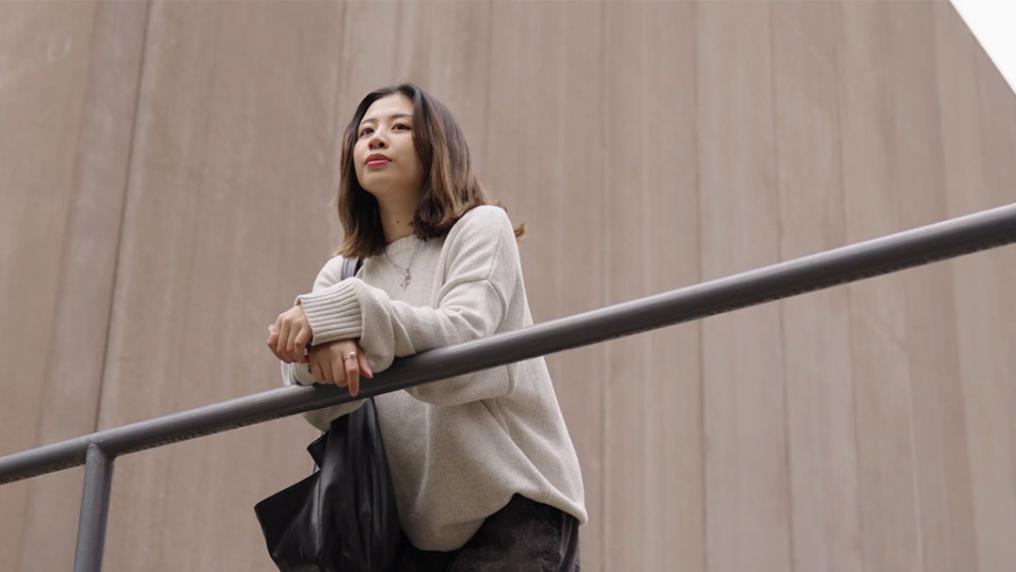 Tracey leans over a railing at VU's Footscray park campus.