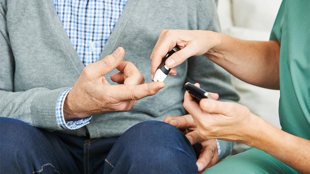 Nurse giving patient a diabetes insulin test.