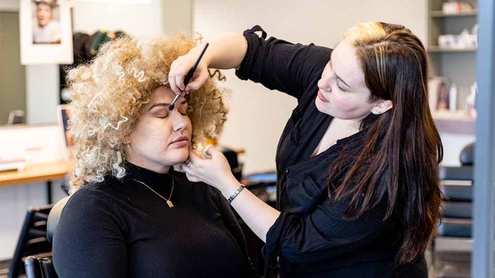 A patron having their make up done at Aura Salon in VU's City Tower.