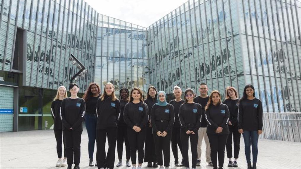 A group of VU's Student Mentors standing in the courtyard outside M Building on VU's Footscray Park campus.