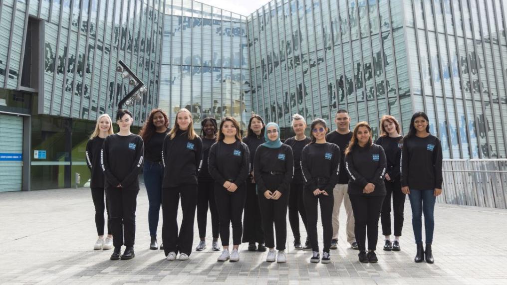 A group of Student Mentors standing on campus