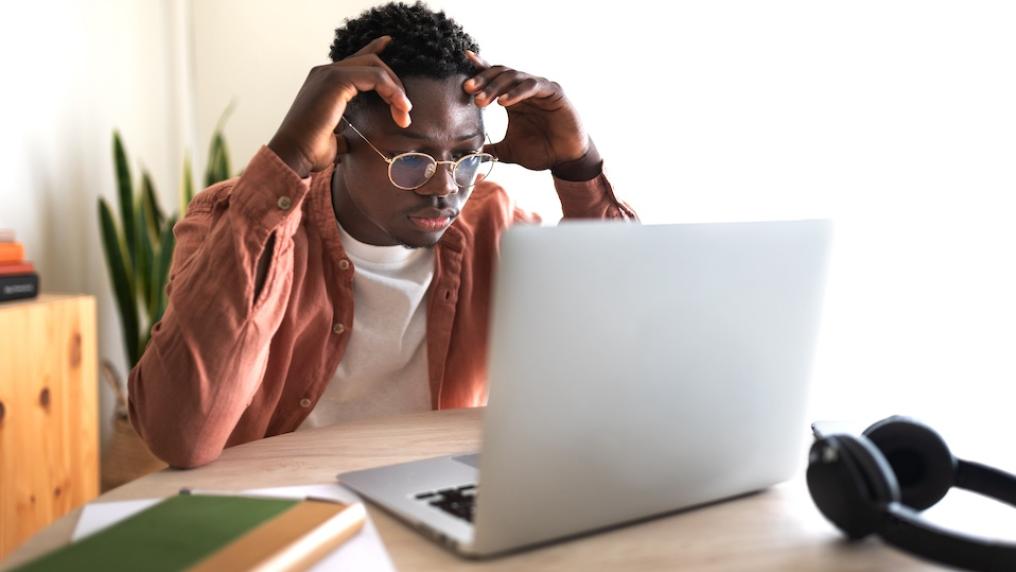 Student looks worried with laptop