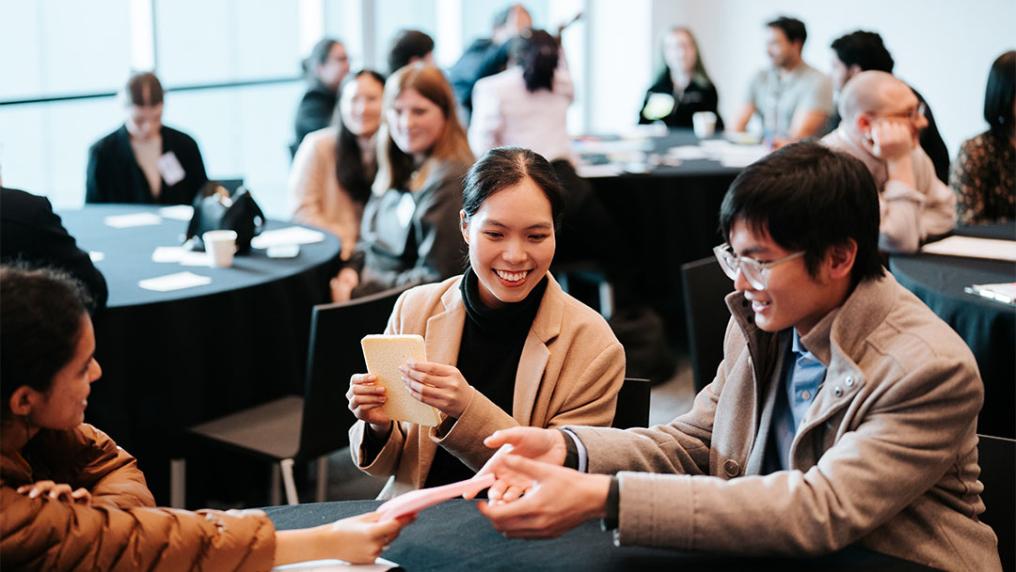 Attendees at Student Leadership Conference grouped around a table.