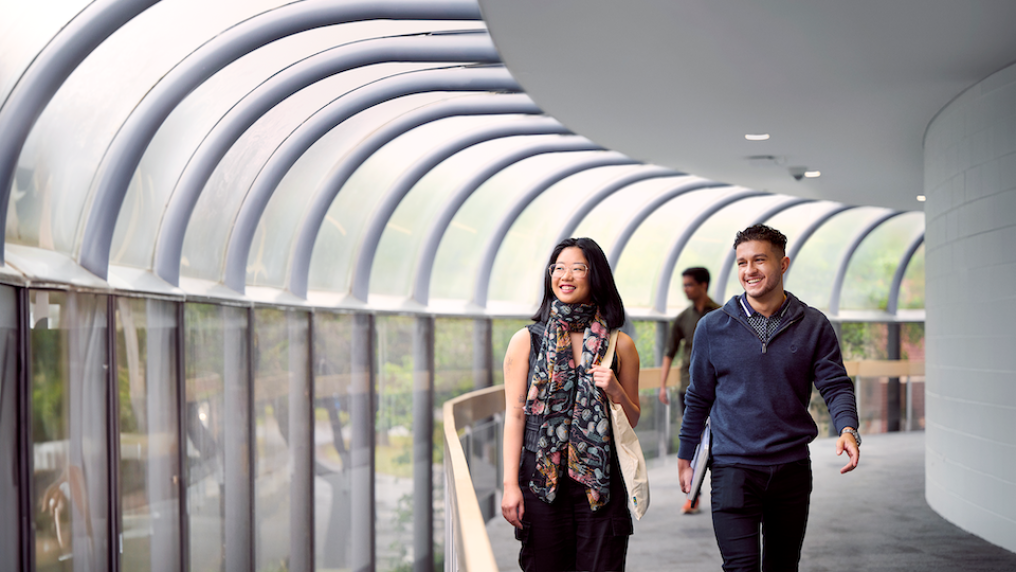 Two students walking in a corridor