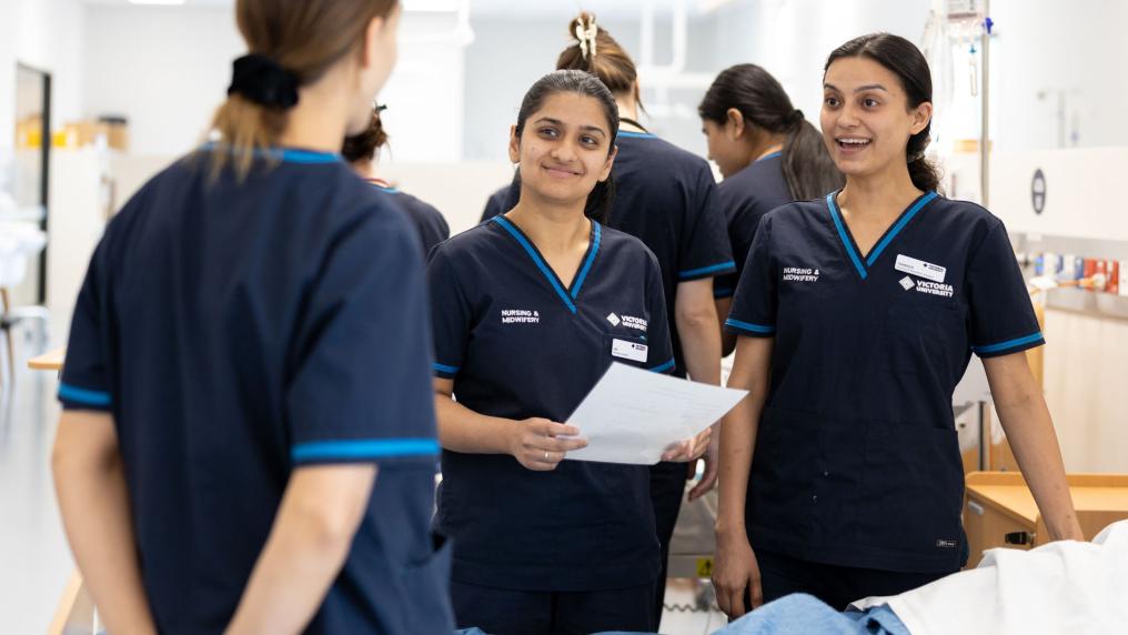 Victoria university nursing students talking to each other in lab