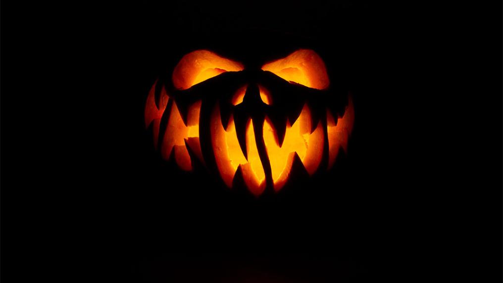 Spooky jack o'lantern lit up from within.