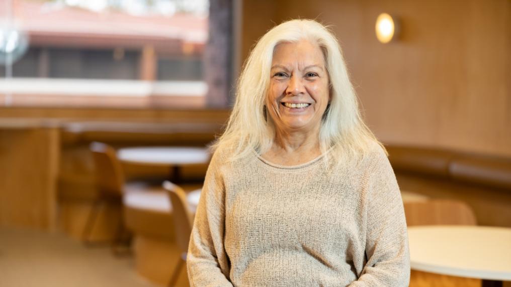 Professional looking woman smiles at the camera.