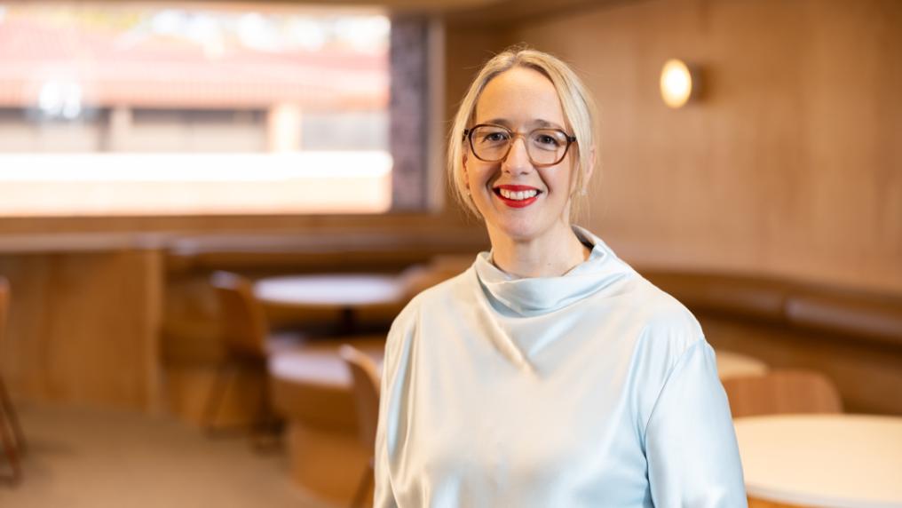 Professional looking woman smiles at the camera.