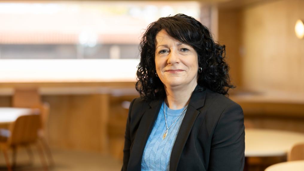 Professional looking woman in suit smiles at the camera.