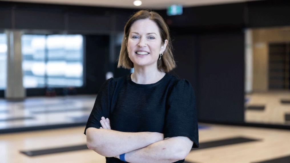 Professor Alex Parker stands in the yoga studio at VU Health Research Facility, at Footscray Hospital. Alex smiles at the camera.
