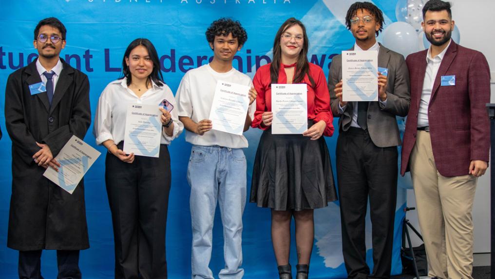 Students pose with VU branded certificates 
