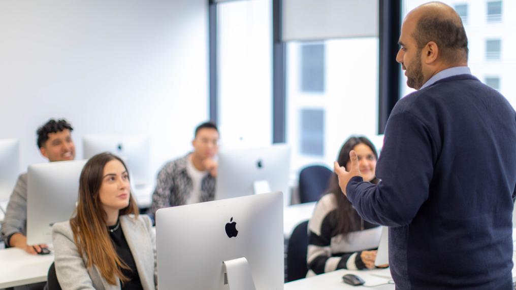 Students in a modern classroom with high-end computers