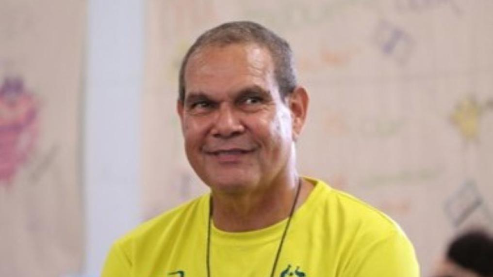 Smiling first nations man in yellow sports t-shirt. 