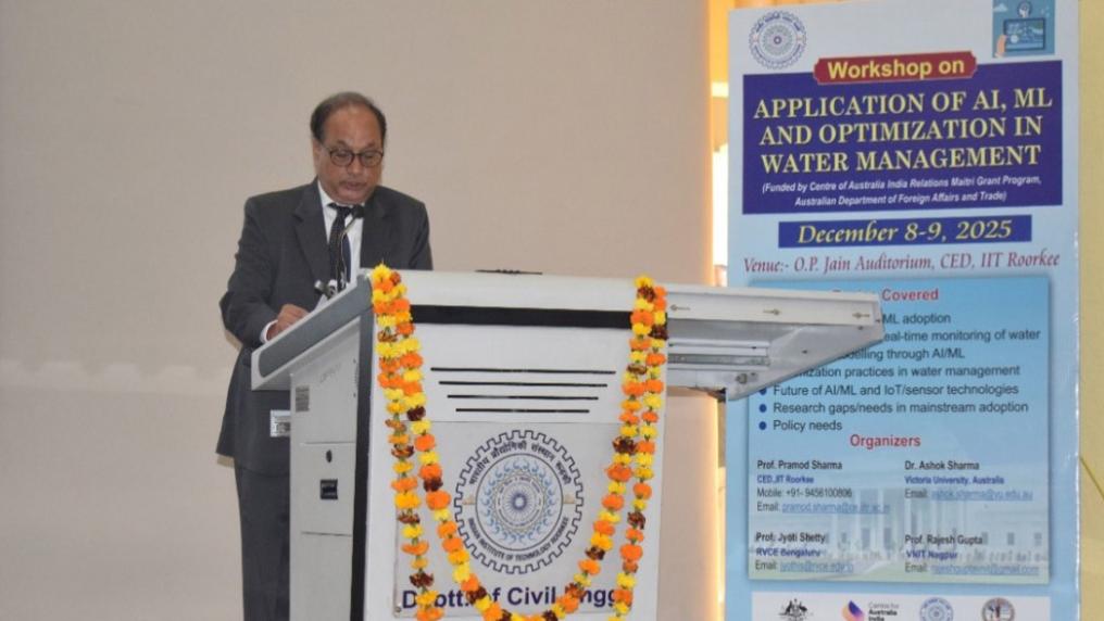 Prof. K K Pant standing behind a podium, speaking.