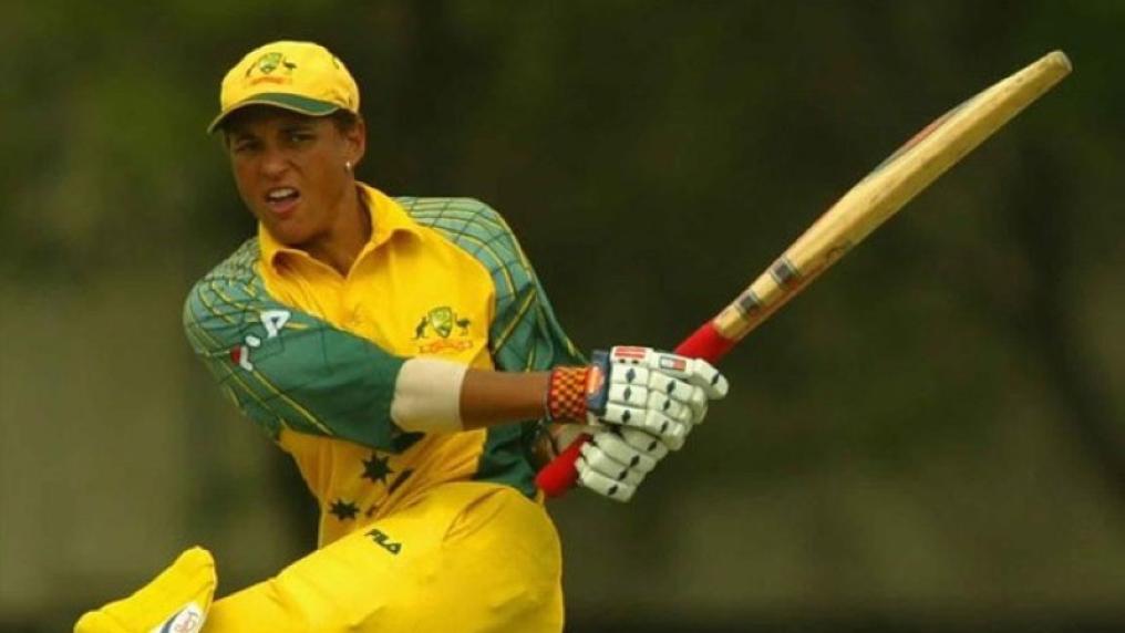 Female cricket player in action swinging cricket bat.