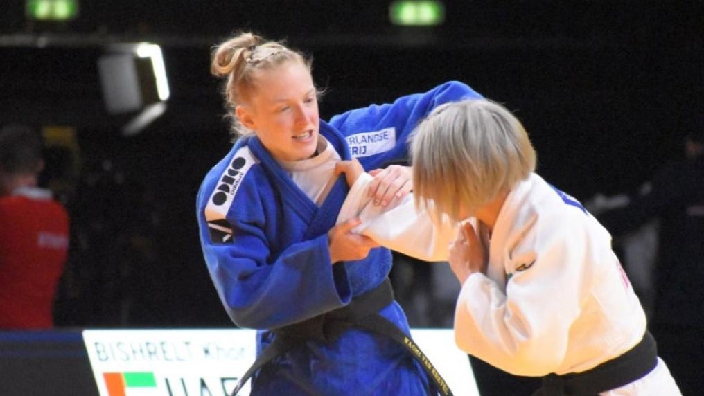  Two female judo athletes in action during match.