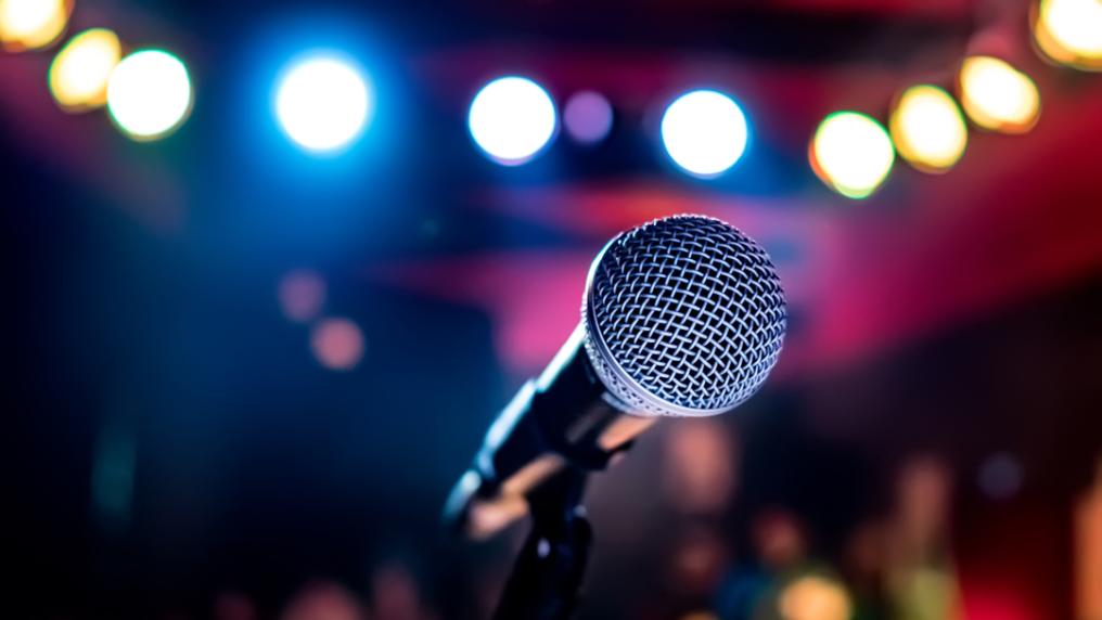 Close up of microphone with blurred background of lights.