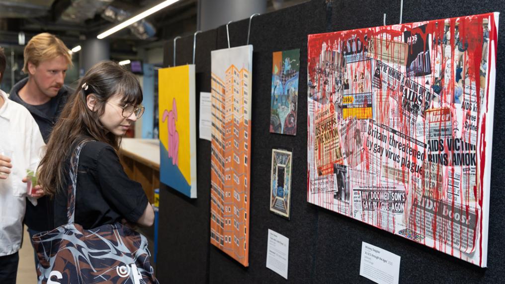 People checking out an exhibition of modernist student-level art