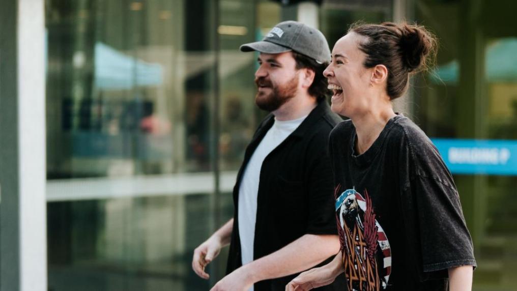 Two people, male and female, playing dancing game at Footscray Park campus