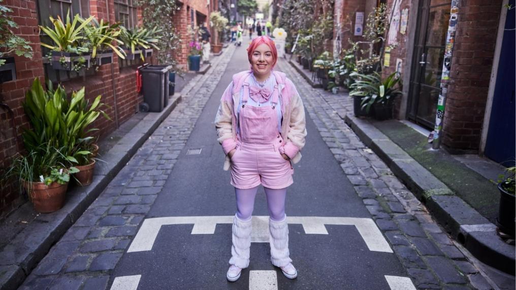 Student standing in Melbourne alley way
