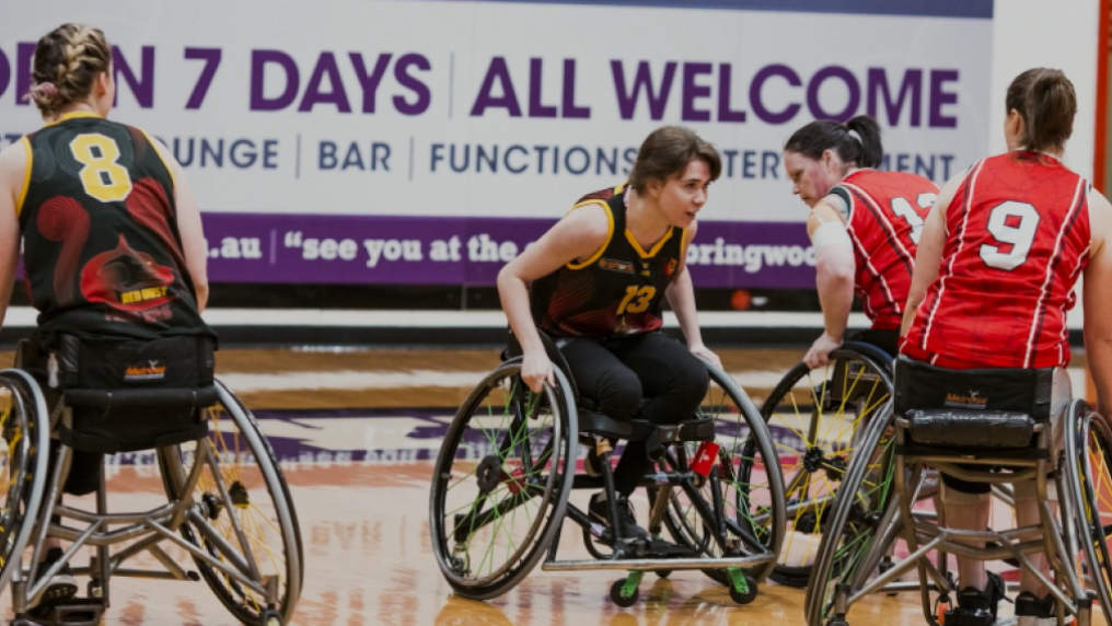 female athlete playing wheelchair basketball