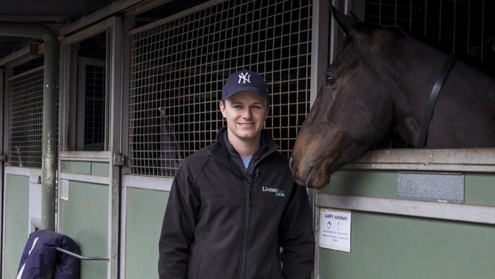 Ben Hayes at a stables with a racing horse