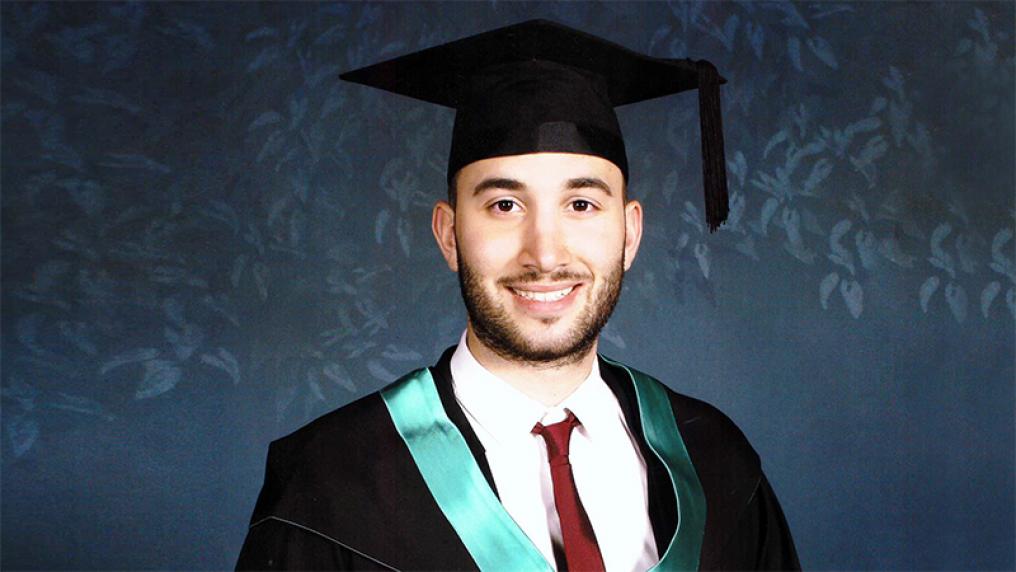 Daniel Zeina in a graduation cap and gown
