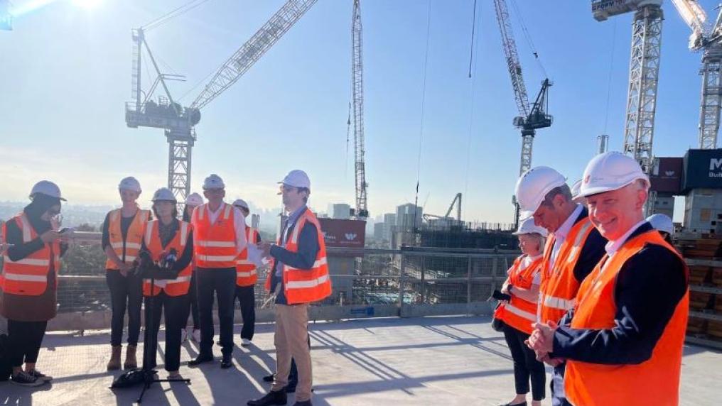  VU leaders with State Government officials in high vis on hospital construction site