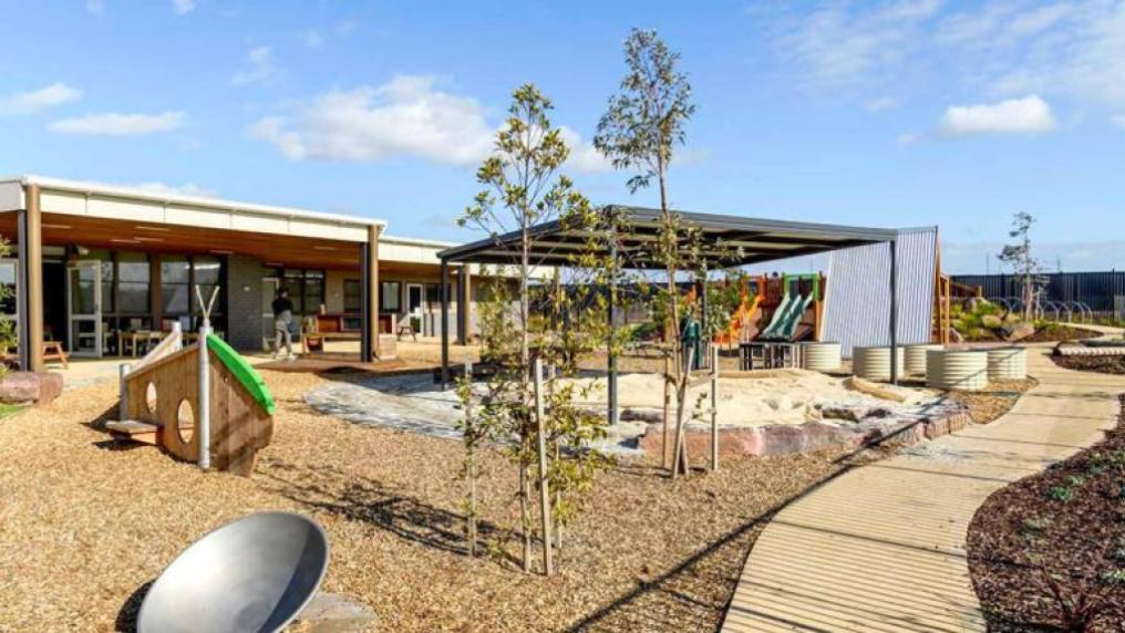 A new community space with playground equipment and modern building