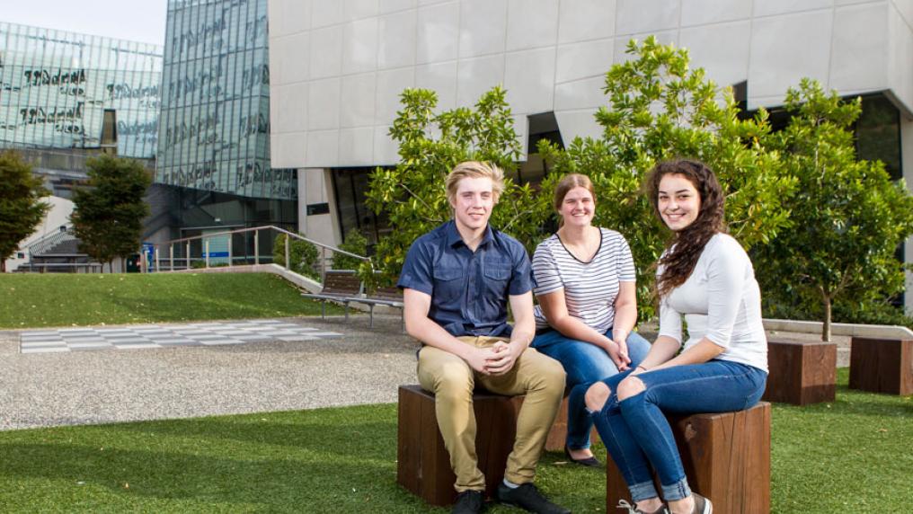 three students on campus
