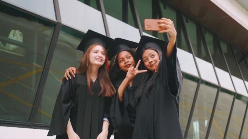 Three female graduates posing together for an informal selfie