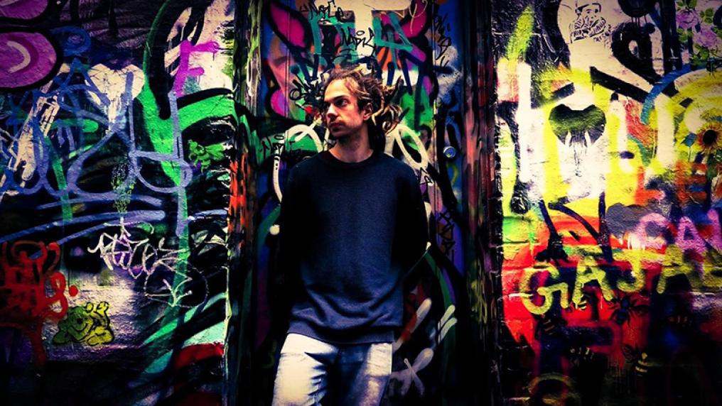 Steven-lay-artist-standing-in-front-of-graffiti-mural