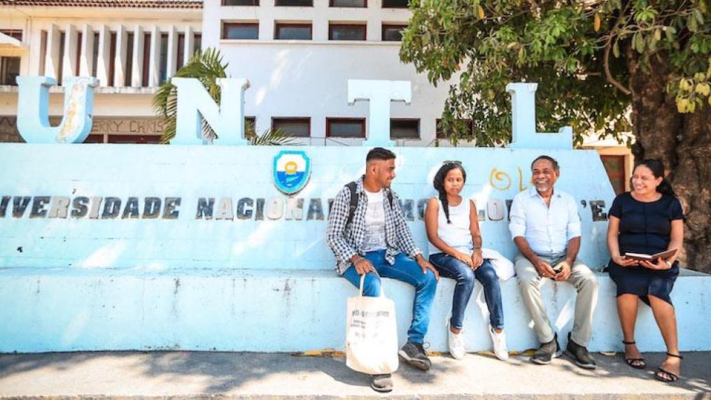 Four people sitting outside the UNTL campus