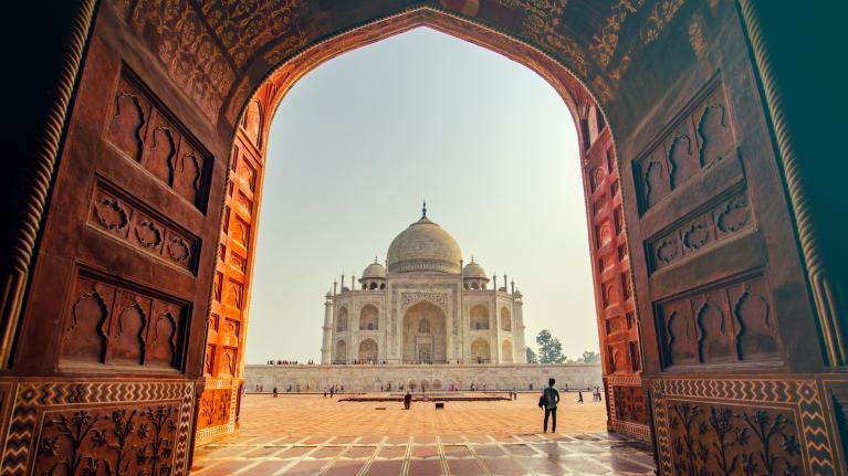 view of taj mahal in india through an archway