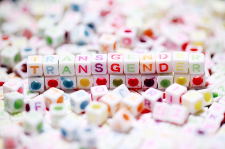 Colourful blocks that spell out the word "transgender".